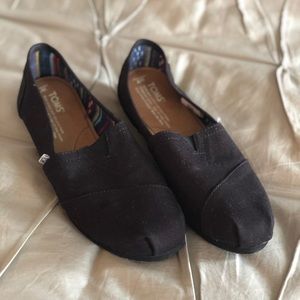 Tom’s black classic slip-ons, size 7